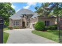 Beautiful brick and stone home featuring a two car garage and a well manicured lawn at 6132 Sharon Rd, Charlotte, NC 28210