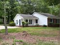 Charming home featuring a well-maintained lawn, a partial brick facade, and eye-catching blue shutters at 7212 Bradley Ct, Charlotte, NC 28227
