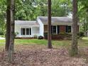 Charming home featuring a well-maintained lawn, a partial brick facade, and eye-catching blue shutters at 7212 Bradley Ct, Charlotte, NC 28227