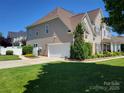 Exterior showcasing the attached garage and manicured lawn of this well-maintained home at 103 Doyle Farm Ln, Mooresville, NC 28115