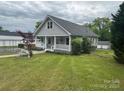 Charming gray two-story house with landscaped lawn and covered front porch at 103 Duke St, Great Falls, SC 29055