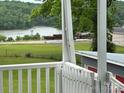 View of the lake from the porch of a property with railings at 103 Duke St, Great Falls, SC 29055