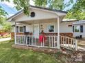 Inviting covered front porch with white railings and brick foundation, perfect for relaxing at 106 Deaver St, Chester, SC 29706