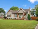 Charming bungalow style home with green grass and a small, manicured tree at 107 Pressley St, Clover, SC 29710