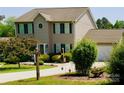 Charming two-story home with a well-manicured lawn, mature landscaping, and inviting curb appeal at 1110 Archer Farm Dr, Salisbury, NC 28144