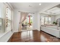 Sun-drenched sun room with hardwood floors, large windows, and sliding door to the patio at 1111 Thessallian Ln, Indian Trail, NC 28079