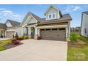 This property features a well maintained lawn and concrete driveway leading up to a two-car garage at 1318 Encore Ln, Waxhaw, NC 28173