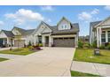 Home with an inviting, well-manicured lawn, complementing the light blue siding and earth-toned driveway at 1318 Encore Ln, Waxhaw, NC 28173