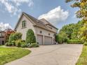 Attached garage with two parking spaces, a large driveway and well-maintained landscaping at 1404 Lookout Cir, Waxhaw, NC 28173
