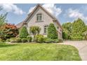 Two-story home featuring an attached garage, well-maintained lawn, and manicured greenery at 1404 Lookout Cir, Waxhaw, NC 28173
