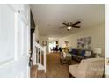 Cozy living room with neutral tones, a ceiling fan, and an open floor plan at 15042 Deshler Ct, Charlotte, NC 28273
