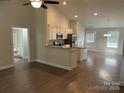 Bright open floor plan with a modern kitchen featuring stainless steel appliances, granite countertops, and hardwood floors at 1521 Park Ave, Salisbury, NC 28146