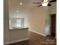 Open-concept living area with lots of natural light, hardwood floors, neutral paint, and views into the kitchen area at 1521 Park Ave, Salisbury, NC 28146