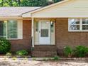 Close-up of the front door with brick facade and well-maintained landscaping at 160 Eagle Dr, Salisbury, NC 28144