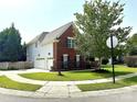 Exterior angle view of a two-story brick home with a white garage door and manicured lawn at 16012 Caranna Ct, Charlotte, NC 28277
