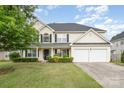 Charming two-story home featuring a well-manicured lawn, a two-car garage, and a classic facade at 170 Glenn Allen Rd, Mooresville, NC 28115