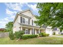 A charming two-story home featuring black shutters, a cozy porch, and a well-maintained lawn at 170 Glenn Allen Rd, Mooresville, NC 28115