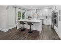Stylish kitchen with a waterfall island, sleek countertops, and modern stainless steel appliances at 17101 Windy Oaks Ct, Cornelius, NC 28031