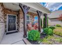 Charming front entrance showcasing stone pillars, seating, and manicured landscaping at 1905 Tranquility Blvd, Lancaster, SC 29720