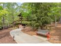 Scenic landscaped walking path leading to a building in a serene, wooded setting at 1905 Tranquility Blvd, Lancaster, SC 29720