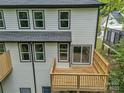 Elevated back view with wooden decks, sliding doors and lots of windows at 1933 St Mark St, Charlotte, NC 28216