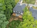 Aerial view of a two-story home showcasing the rear wood decks amidst lush greenery at 1935 St Mark St, Charlotte, NC 28216