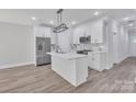 Modern kitchen featuring white cabinets, stainless steel appliances, and a stylish center island at 1935 St Mark St, Charlotte, NC 28216