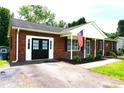 Inviting brick home with a double door entrance, patriotic flag, and well-kept landscaping at 1958 19Th Avenue Ne Dr # 8, Hickory, NC 28601