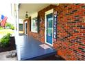 Cozy front porch with brick siding, patriotic decorations, and a welcoming entrance at 1958 19Th Avenue Ne Dr # 8, Hickory, NC 28601
