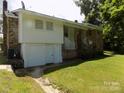 View of the back of the house with a walk out basement and access to the backyard at 209 Barber Rd, Gastonia, NC 28056