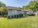 Attractive single-story house featuring gray siding and well-maintained landscaping for enhanced curb appeal at 214 Wilcrest Dr, Matthews, NC 28105
