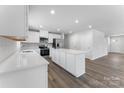 A full kitchen view features white cabinets and countertops with stainless steel appliances at 217 Basildon St # 1018, Lancaster, SC 29720