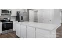 Bright kitchen with white cabinets, stainless steel appliances, and a large center island at 217 Basildon St # 1018, Lancaster, SC 29720