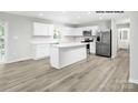 Bright kitchen features an island, stainless appliances, white cabinets, and ample counter space at 217 Basildon St # 1018, Lancaster, SC 29720