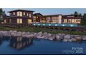 Modern home exterior featuring a pool and waterfront view, perfect for relaxation at 22554 John Gamble Rd, Cornelius, NC 28031