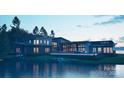 Modern waterfront home with panoramic views, pool, and outdoor seating areas at 22554 John Gamble Rd, Cornelius, NC 28031