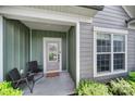 Welcoming entryway with covered porch, seating, and sidelight windows, offering both style and curb appeal at 2364 Delaney Dr, Fort Mill, SC 29715