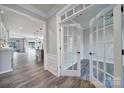 Elegant entryway showcasing an open floor plan with hardwood floors, framed door, and stylish decor at 2364 Delaney Dr, Fort Mill, SC 29715