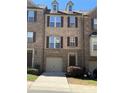 Attractive brick townhome with an attached garage, dormer windows, and well-maintained landscaping at 243 Lincoln St, Charlotte, NC 28203