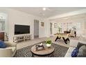 Spacious living room features a foosball table, modern decor, and ample natural light for entertaining and relaxation at 243 Lincoln St, Charlotte, NC 28203