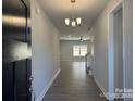 Welcoming entryway featuring wood-look floors, modern chandelier, and neutral paint throughout the home at 2924 Noritake Trl # 67, Albemarle, NC 28001