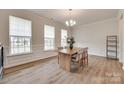 Elegant dining room featuring hardwood floors, a chandelier, and large windows at 3101 Virginia Trail Ct, Fort Mill, SC 29715