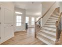 Bright entryway with hardwood floors, a staircase, and natural light from the front door at 3101 Virginia Trail Ct, Fort Mill, SC 29715