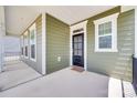 A covered front porch with a black door, white trim, and multiple windows at 3101 Virginia Trail Ct, Fort Mill, SC 29715