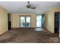 Bright living room with a ceiling fan, leading to an inviting outdoor area through glass doors at 3103 Blue Ridge Dr, Shelby, NC 28150