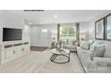 A living room featuring neutral walls, carpet flooring, comfortable seating, and bright natural light at 336 Maplestead St # 1080, Lancaster, SC 29720