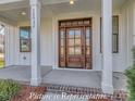 Elegant front door with sidelights and transom windows, framed by white columns on a covered porch at 3439 Stags Leap Way, York, SC 29745