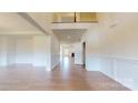 Bright foyer with wainscoting, hardwood floors, and an open staircase leading to the second floor at 3719 Wave Rock Ct, Fort Mill, SC 29707