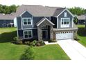 Charming two-story home with a manicured lawn, stone accents, and an attached two-car garage at 3719 Wave Rock Ct, Fort Mill, SC 29707