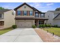 Charming two-story home with a two-car garage, neutral siding and manicured landscaping. Property address visible on the front at 392 Winecoff Woods Nw Dr, Concord, NC 28027